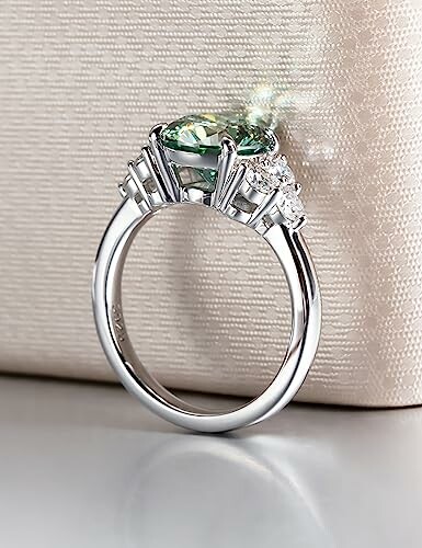 Elegant diamond ring with a green gemstone.