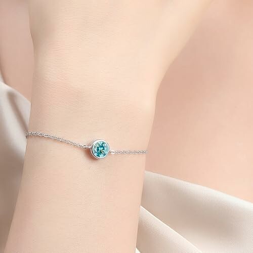 Elegant silver bracelet with blue gemstone on wrist